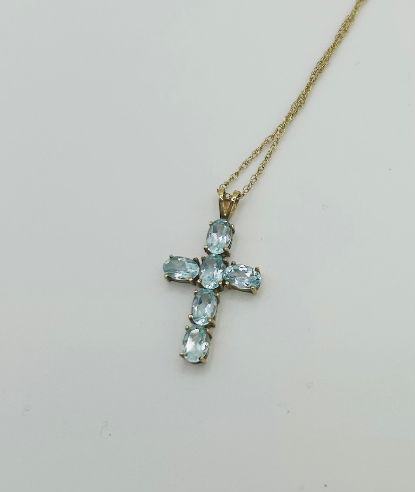Topaz cross on a gold chain