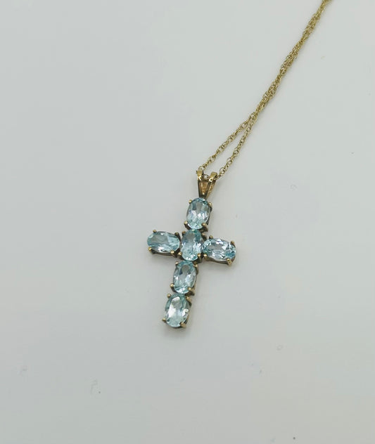Topaz cross on a gold chain