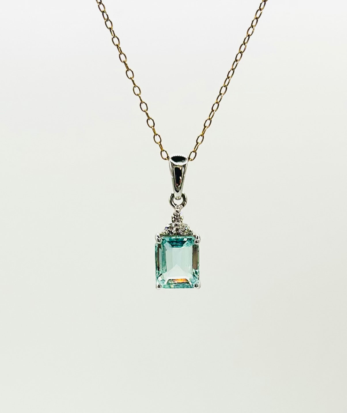 Aquamarine & diamond pendant on a gold chain