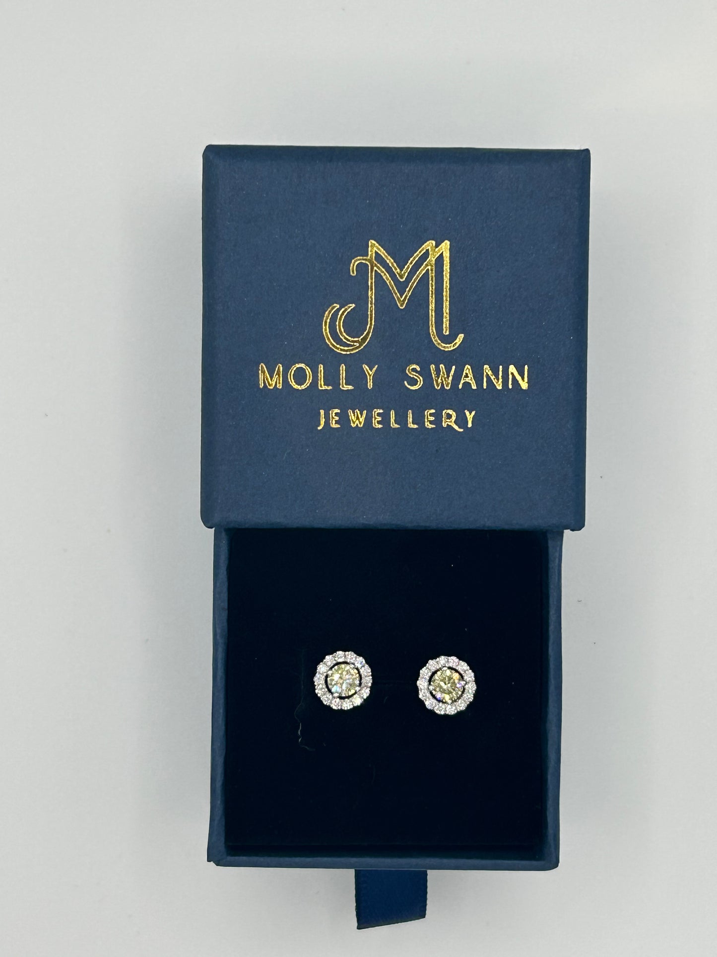 Yellow diamond studs surrounded by brilliant cut diamonds set in 14k white gold