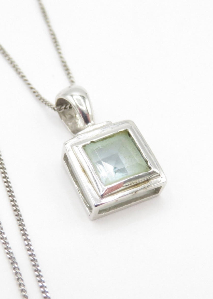 Blue topaz and white gold pendant on a white gold chain