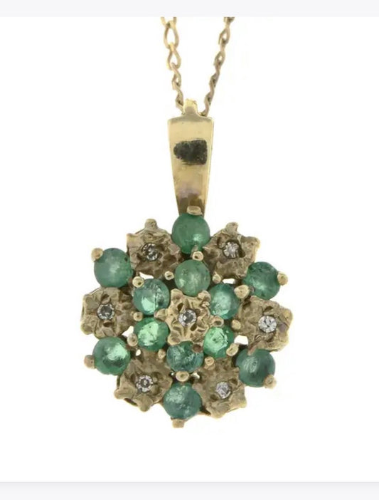 Emerald and diamond pendant on a gold chain