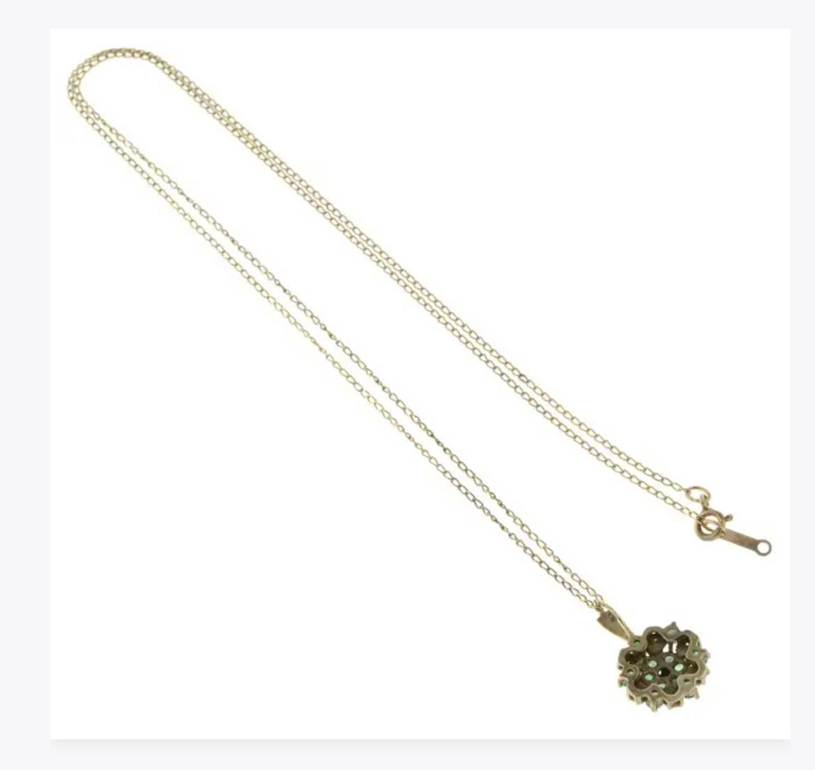 Emerald and diamond pendant on a gold chain