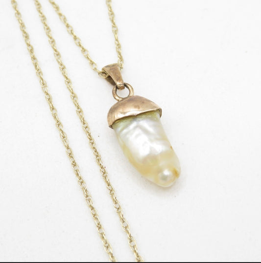 Dogtooth pearl pendant on a gold chain