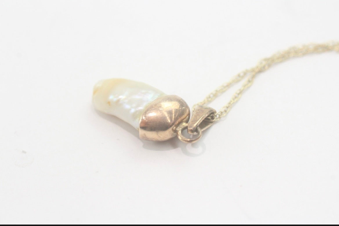 Dogtooth pearl pendant on a gold chain